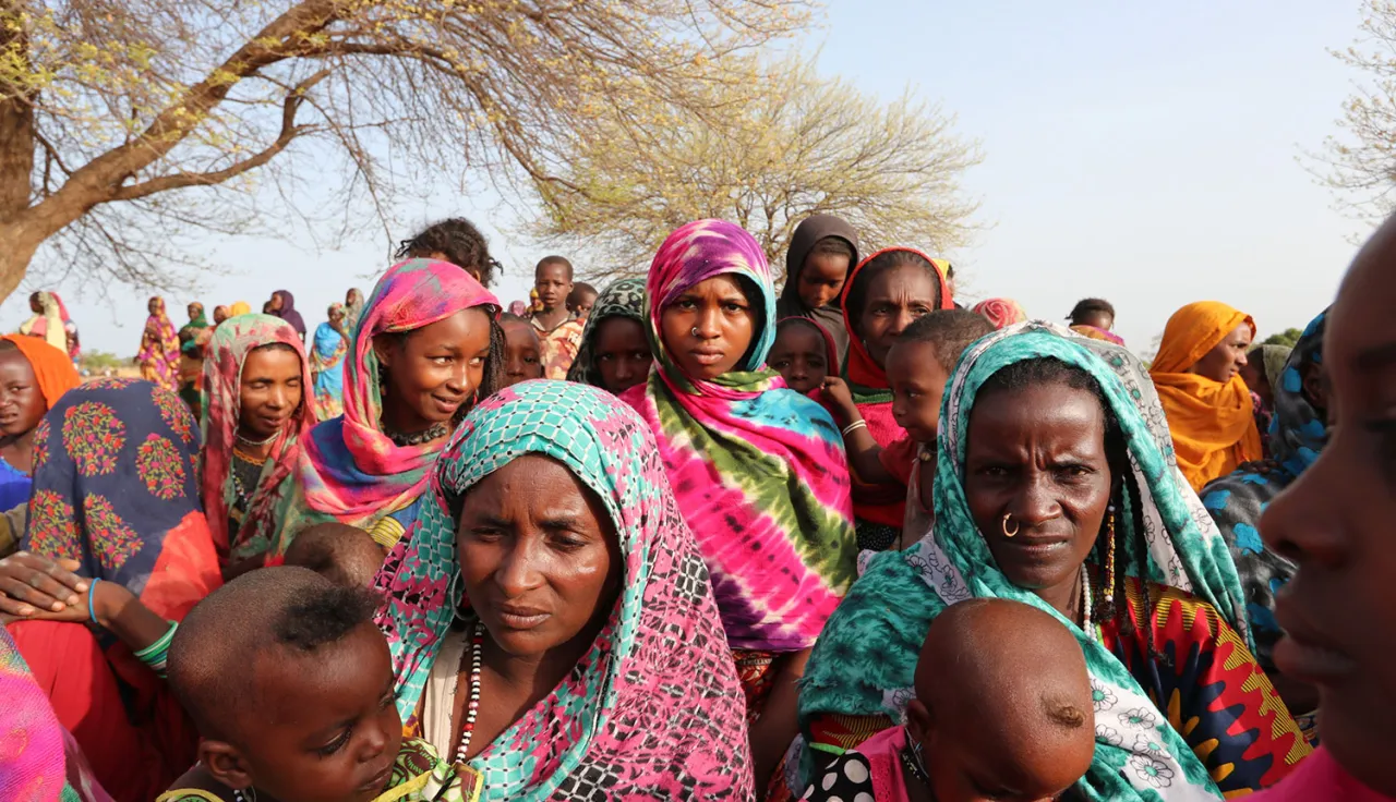 A group of African women and children facing the camera.