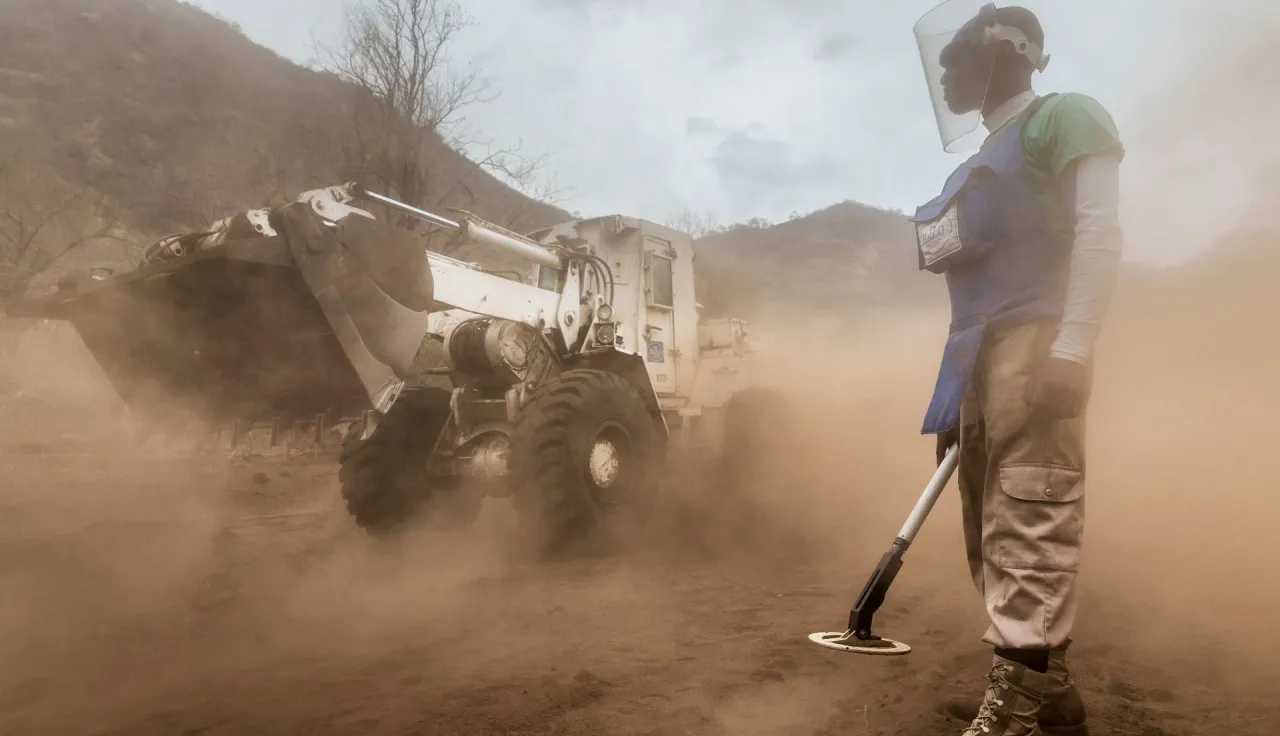 Tete Province, Chinzunga Hills, close to Cabora Bassa. A HALO Trust deminer watches a bulldozer scrap up mines.