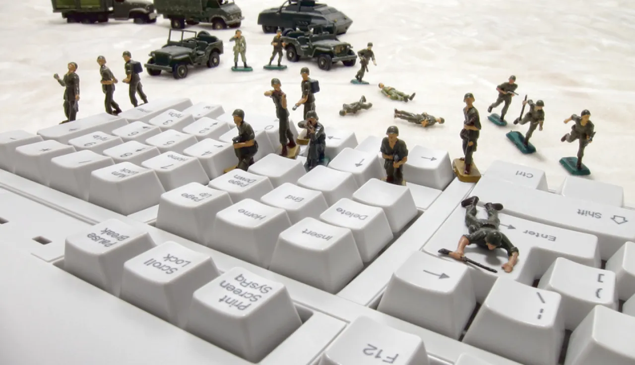 Toy soldiers on the buttons of a computer keyboard