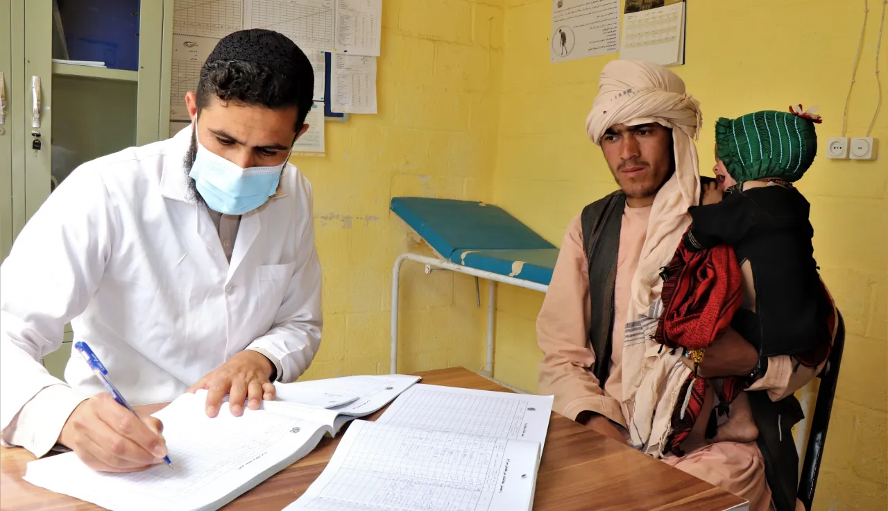 A healthcare worker providing consultation to a patient in Farah, Afghanistan