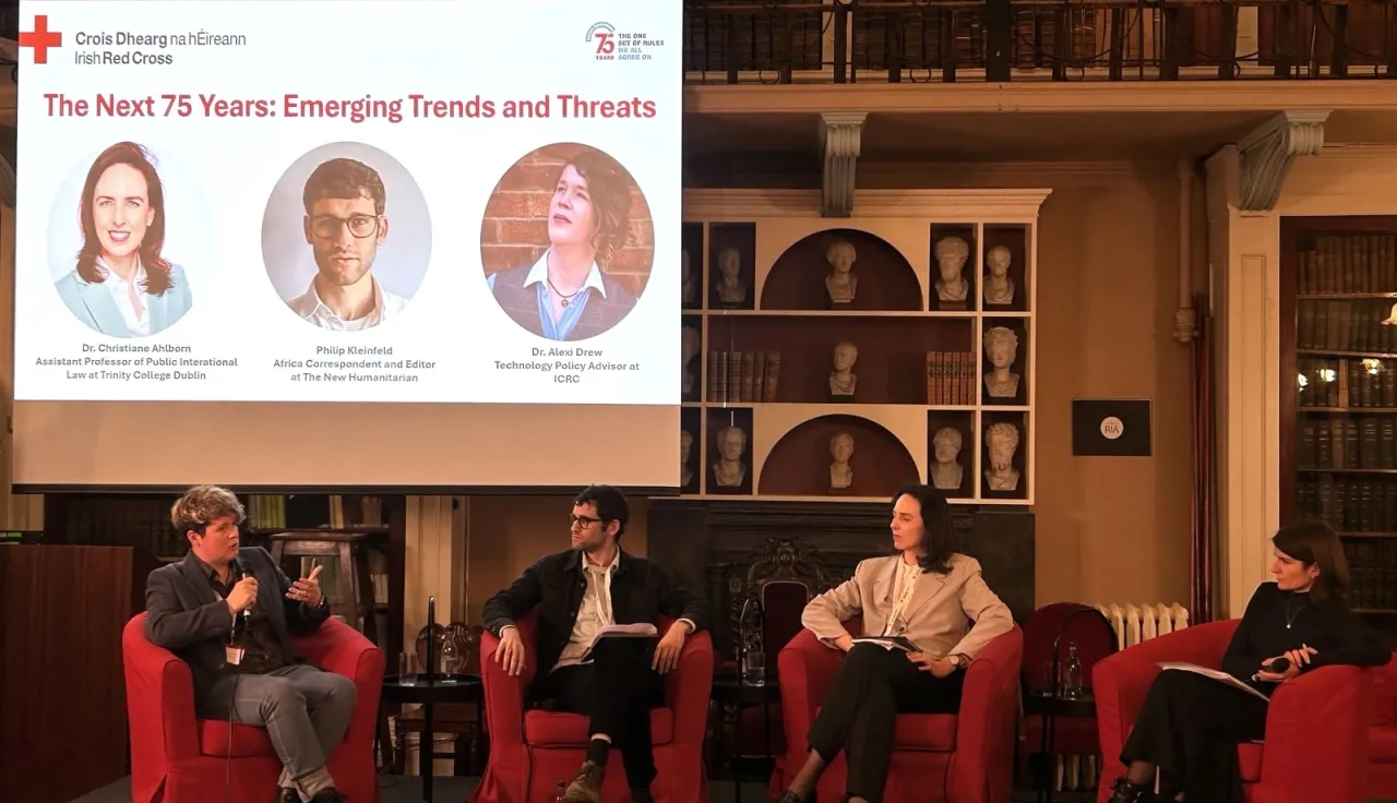 Four people sat on a stage holding a discussion