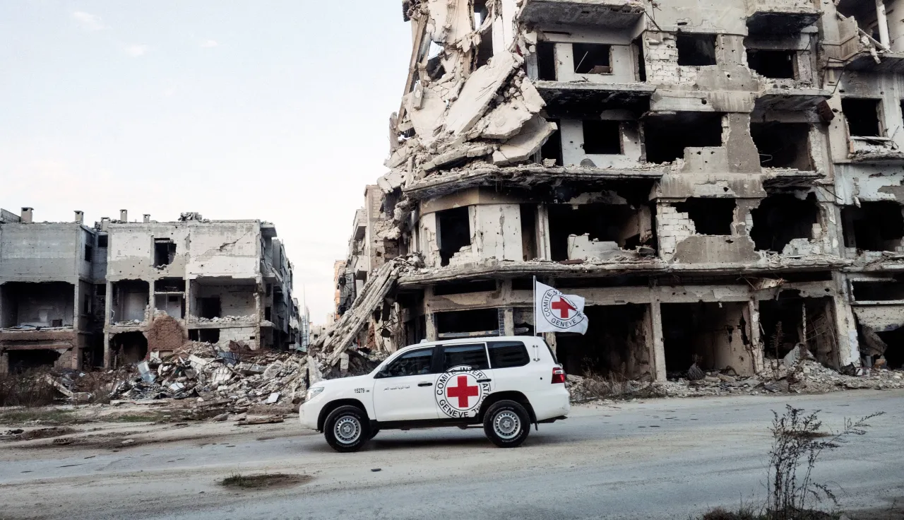 ICRC land cruiser in Homs, Syria. Jérôme SESSINI/ICRC ICRC land cruiser in Homs, Syria, driving past a collapsed building