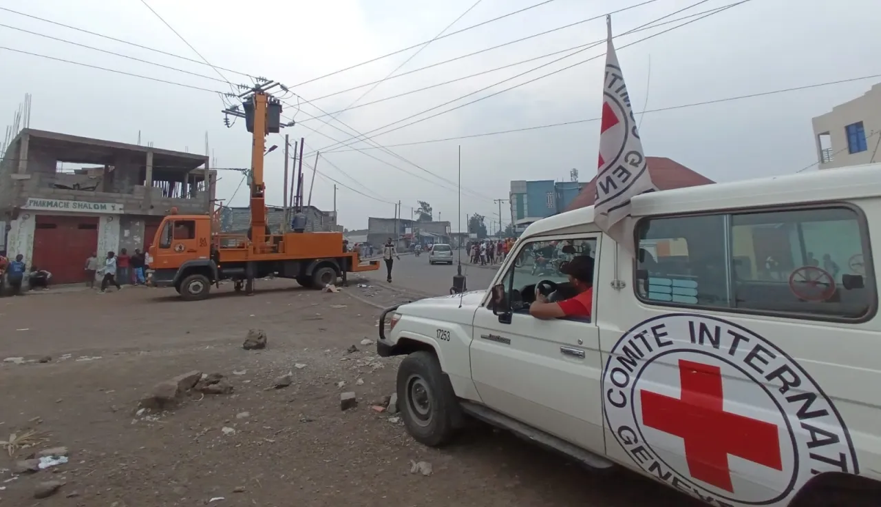 DRC essential infrastructure Goma ICRC landcruiser next to electricity pylons in Goma