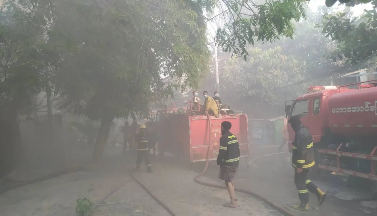 Earthquake response: Firefighters in protective gear work to control a fire, surrounded by smoke, trees, and fire trucks in Mandalay, Myanmar, following the massive earthquakes which hit the country over the weekend. ICRC Firefighters in protective gear work to control a fire, in Mandalay, Myanmar, in response to the massive earthquakes which hit the country over the weekend.