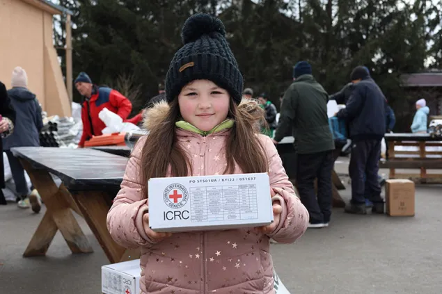Young girl holding ICRC kit