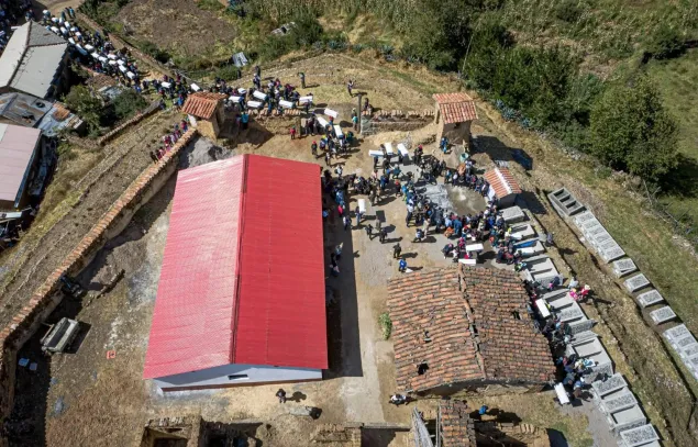 Vista aérea de una peregrinación con ataúdes y familiares de personas desaparecidas en una localidad en Perú.