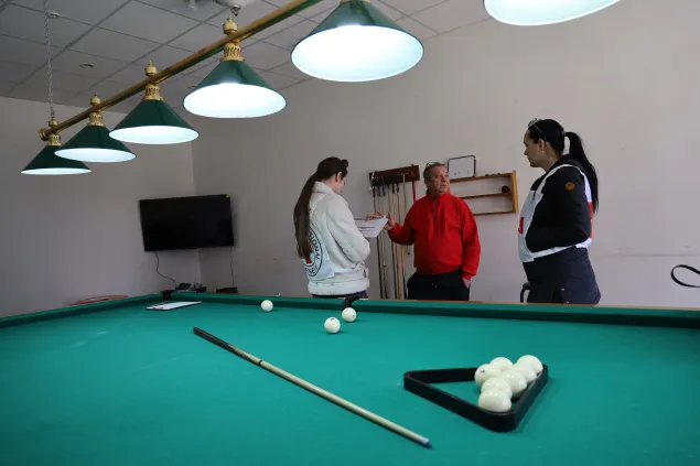 ICRC staff interviews Yuri Menshikov in his billiards café.