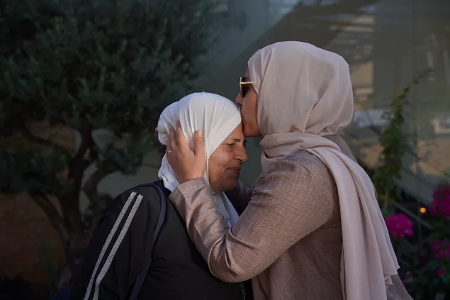IDOD Jordan 4 A woman kisses another woman on the forehead
