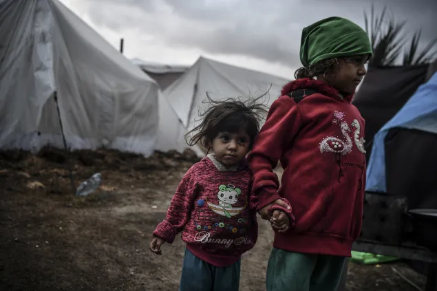 Gaza, Khan Yunis. Two sisters wander through a makeshift camp amidst the rubble of the city. They had to flee their home because of the conflict escalation.