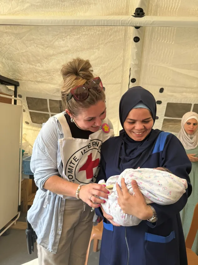 Baby Asia - born while stray bullets were around the field hospital in gaza - with midwife Falasteen Qishta and ICRC staff member Sarah Davies.jpg Baby Asia - born while stray bullets were around the field hospital in gaza - with midwife Falasteen Qishta and ICRC staff member Sarah Davies.jpg