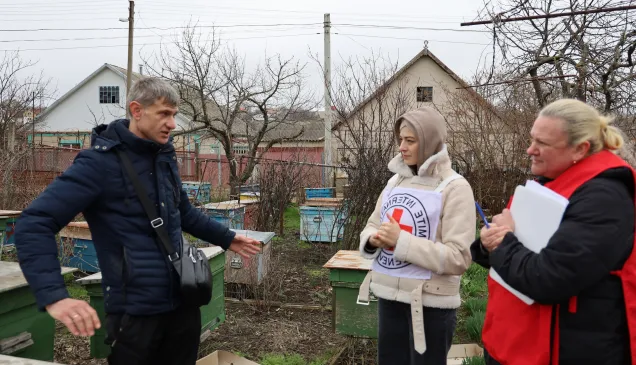 ICRC staff interviews man on beekeeping in the cash-for-livelihood programme in Moldova. ICRC