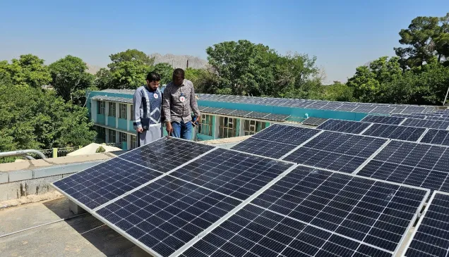 ICRC Water and Habitat staff inspecting the newly installed solar hybrid power system at Mirwaid Regional Hospital in Kandahar