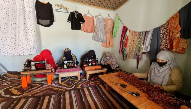 Nilofar Akbari (far right) and four other women working in a tailoring shop in Mazar-i-Sharif.