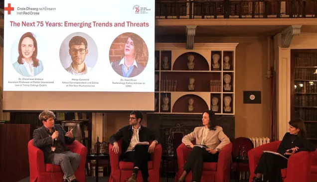 Four people sat on a stage holding a discussion