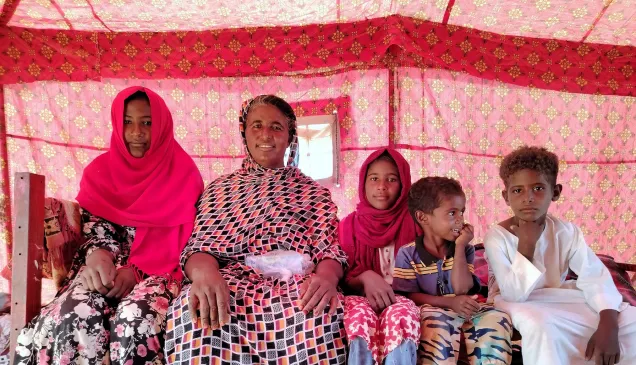 of survival and resilience. Khaldia with four of her children; the rest of her family has been displaced and scattered across Sudan.