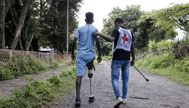 Tigray, Shire Hospital. A member of ICRC's physical rehabilitation team helps a patient practice walking with his prosthesis. Alyona Synenko/ICRC Tigray, Shire Hospital. A member of ICRC's physical rehabilitation team helps a patient practice walking with his prosthesis.