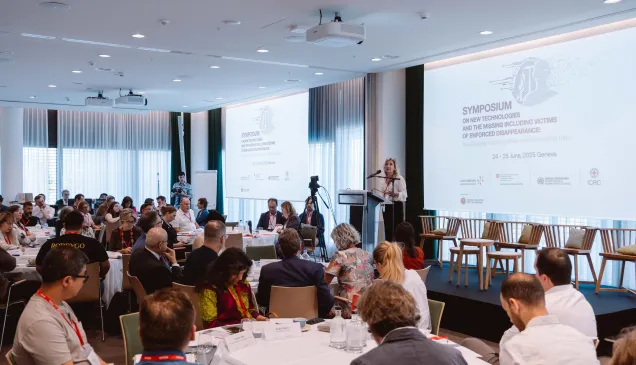 Opening plenary of the Symposium on New Technologies and the Missing, including Victims of Enforced Disappearance, held in Geneva on 24 and 25 June 2025. Group of search practioners and experts from various sectors in a conference room with a speaker on the stage
