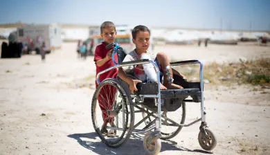 ICRC_Injured child in a wheelchair with a friend_Photo: Mari Mortvedt