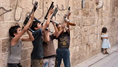 Aleppo, Syria. Young boys imitate with their homemade toys the soldiers they see. Hagop Vanesian/ICRC