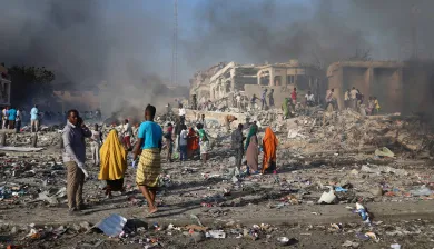 Civilians prepare to carry dead bodies of unidentified persons after an explosion in Mogadishu, Somalia.