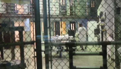  Guantanamo Bay, United States detention facility, Camp 6. The bulk of the detainees live in Camps 5 and 6. This image, taken from outside a communal cell block in Camp 6, shows a detainee with his back towards the door.