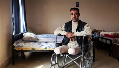 Un hombre que perdió las dos piernas sendado en una silla de ruedas.