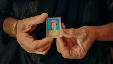 Missing Iraq A woman in iraq holds a passport sized photograph of a missing relative