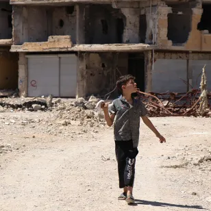 Child walking the rubble in Syria.