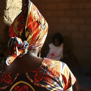 An ICRC staff member listens to the story of a woman who experienced depression after her husband was killed by an armed group. 