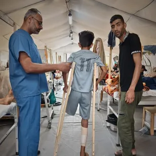 An ICRC phsyiotherapist with a young patient at the Red Cross Field Hospital.l. An ICRC phsyiotherapist with a young patient at the Red Cross Field Hospital.l.