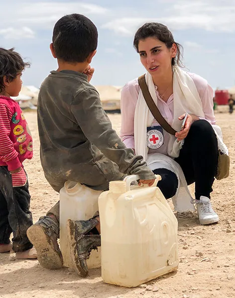 ICRC helps people in  conflict areas, woman helping some children 