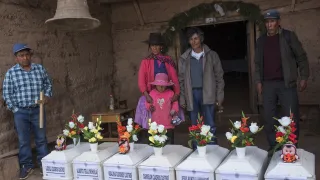In Peru, relatives of individuals missing for 30 years ceremoniously bury 12 individuals whose remains have been found and identified. 