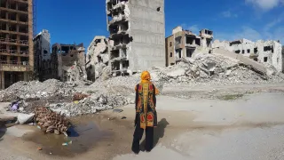 A woman amidst the city ruins after heavy fighting in Benghazi, Libya.