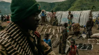 Congolese army units drive past displacement camps. 08 April, Sake, North Kivu Province, Democratic Republic of Congo. Sake was a key objective of an M23 offensive seeking to isolate the city of Goma. 