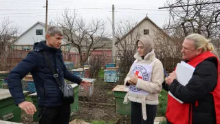ICRC ICRC staff interviews man on beekeeping in the cash-for-livelihood programme in Moldova. ICRC