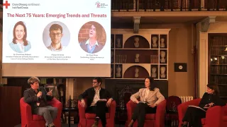 Four people sat on a stage holding a discussion