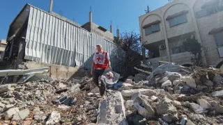 ICRC staff assessing a collapsed building