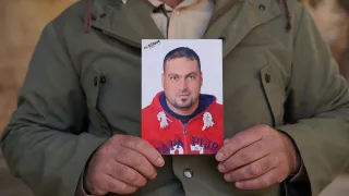 A brother of Family of missing holding his picture