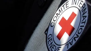 An image shows the emblem of the International Committee of the Red Cross