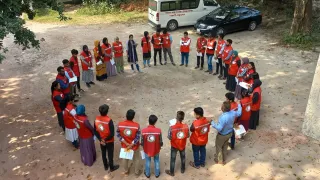 Bangladesh access training ICRC staff standing facing each other in a circle with picture taken from above