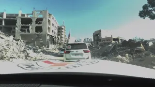 eturn-to-North-Gaza-ICRC-01 ICRC Landcruisers driving past fallen buildings