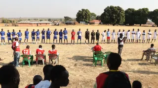 The Downtown and Blue Star football teams line up before kickoff. Photo: Junior Ali/ICRC
