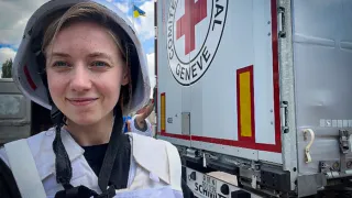 ICRC in Ukraine An ICRC worker standing in front of a marked truck