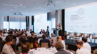Opening plenary of the Symposium on New Technologies and the Missing, including Victims of Enforced Disappearance, held in Geneva on 24 and 25 June 2025. Group of search practioners and experts from various sectors in a conference room with a speaker on the stage