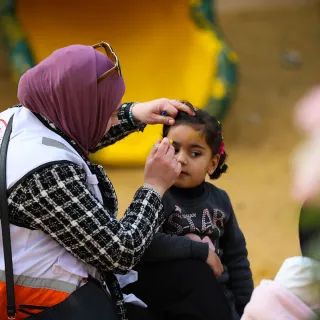 ICRC_Delegate helping a child