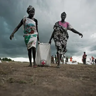 Women collecting sorghum and oil hours after an ICRC airdrop in Unity State, South Sudan - 2014. Jacob Zocherman/ICRC