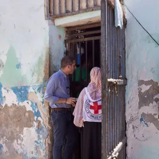 ICRC delegates talking in a doorway