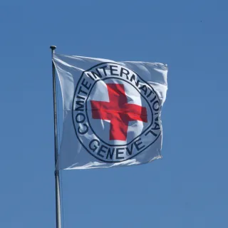 Emblem ICRC flad and blue sky