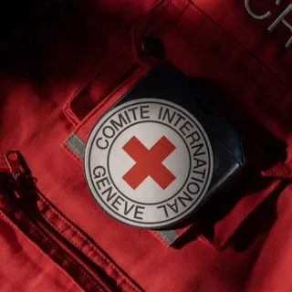 Close-up of red ICRC vest with ICRC emblem on the pocket Close-up of red ICRC vest with ICRC emblem on the pocket