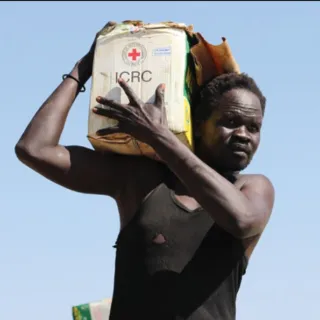 ICRC in South Sudan Man carries a water tank with an ICRC logo on it on his shoulder